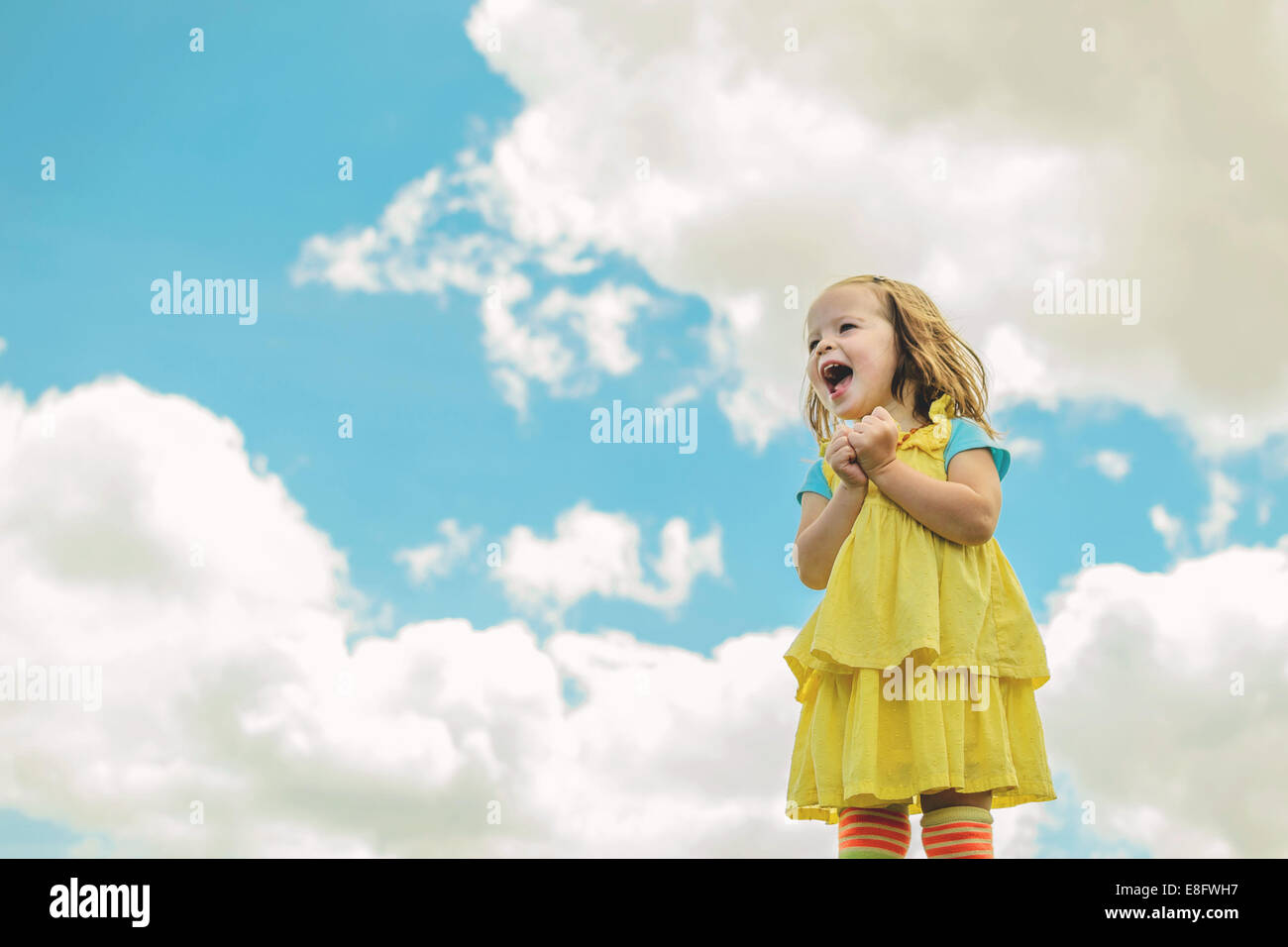 Girl (2-3) laughing with sky in background Stock Photo