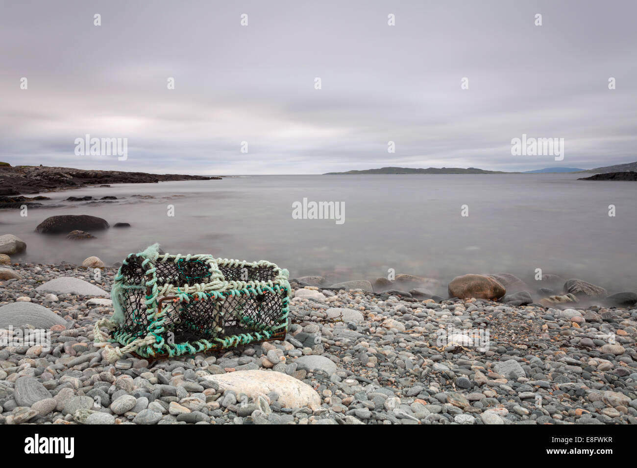 Lobster pot washed up on pebbly beach Isle of Harris, Scotalnd Stock Photo