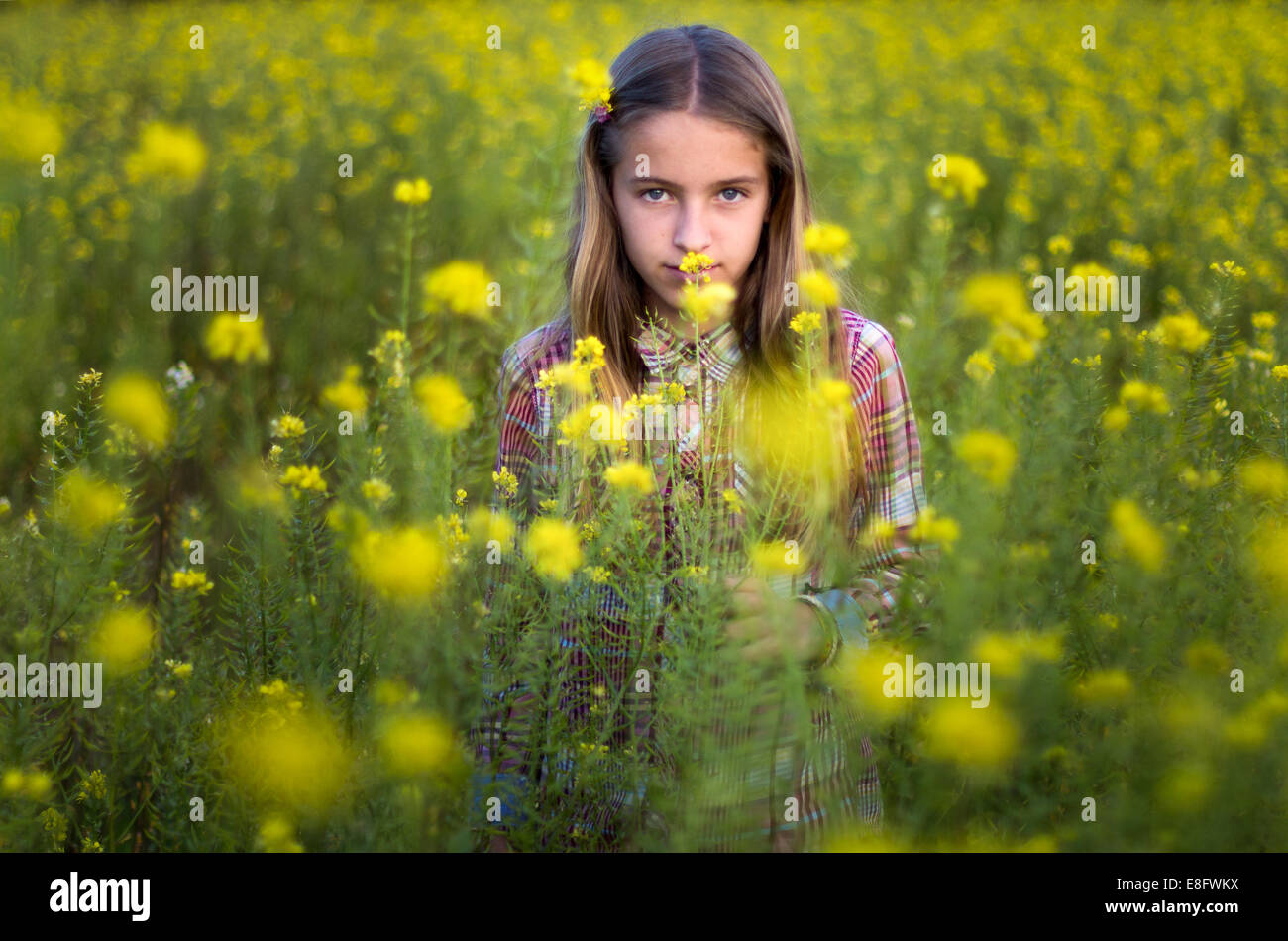 Portrait of girl standing in meadow Stock Photo - Alamy