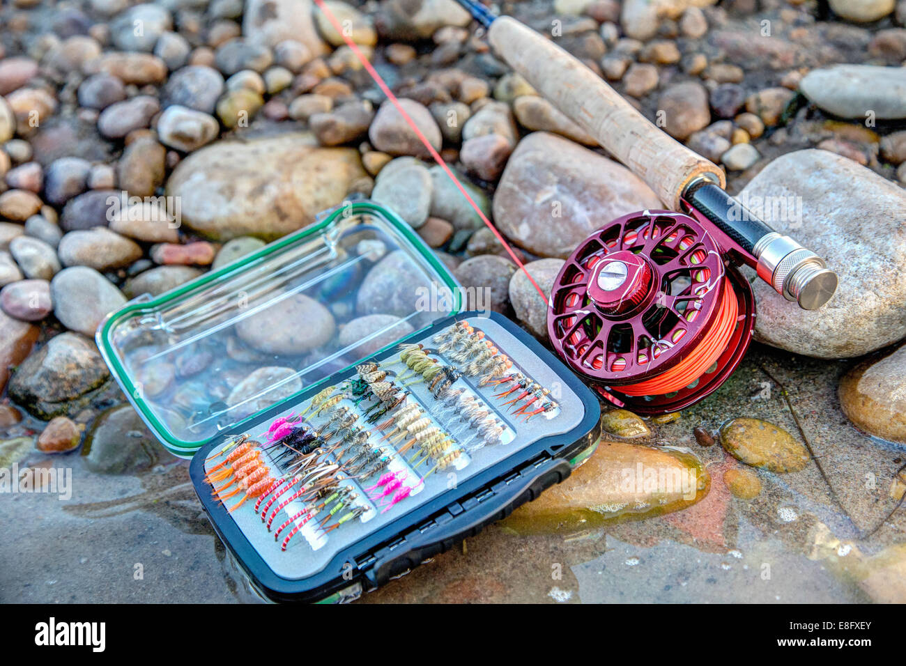 Close-up of Fishing tackle on a riverbank with a fishing rod Stock Photo