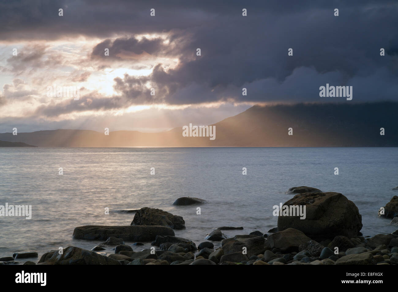 Rays of sunlight shining through the clouds Elgol Isle of Skye Scotaland Stock Photo