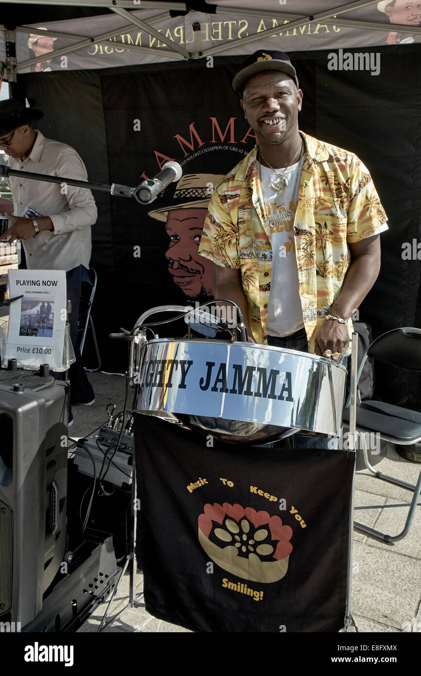 Jamaican Busker playing steel drum instrument on a UK street
