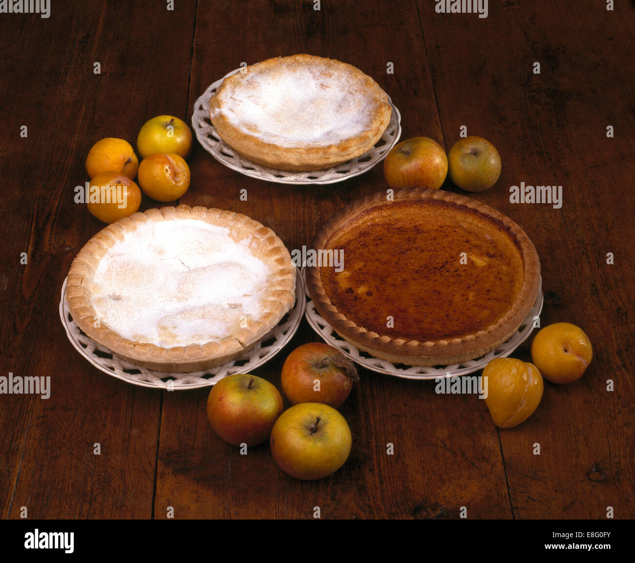 Close-up of apple pies with fresh apples and plums Stock Photo
