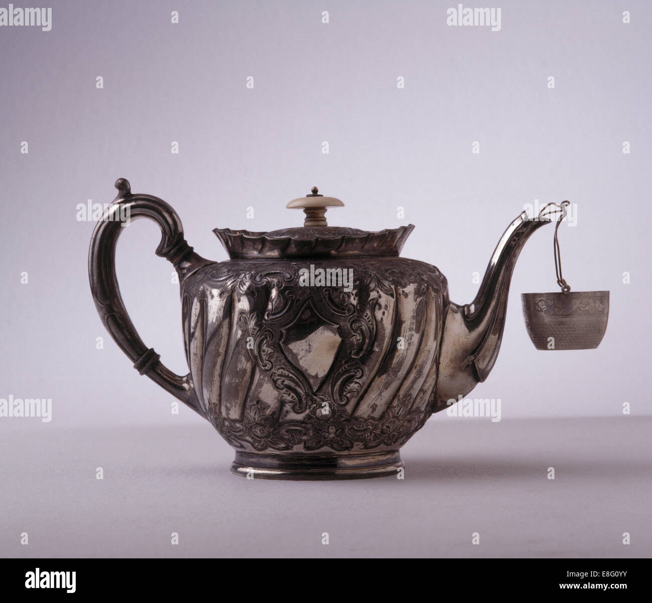 Close-up of silver Georgian teapot with strainer Stock Photo