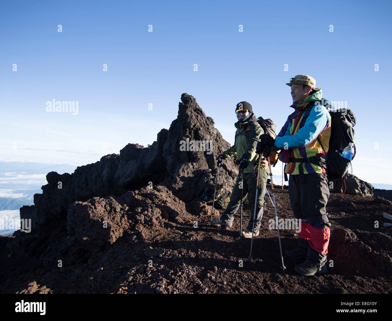 Climbing Mt. Fuji, JAPAN - Japanese hikers at the summit at dawn Stock Photo