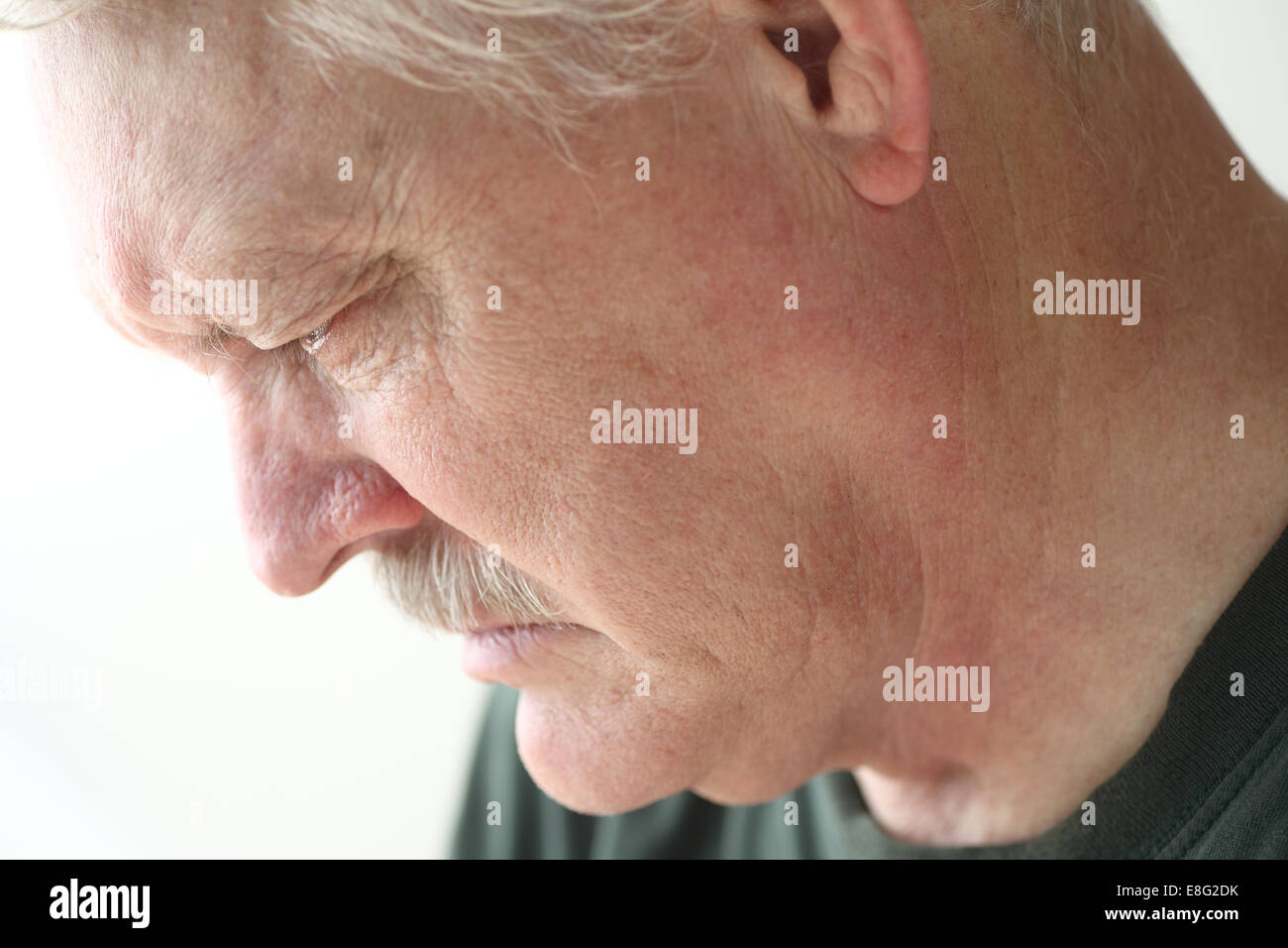 Downcast senior man with an expression of sadness, depression or grief Stock Photo