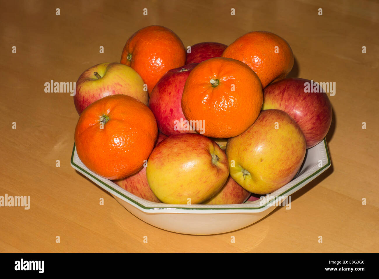 Oranges and apples in bowl still life Stock Photo