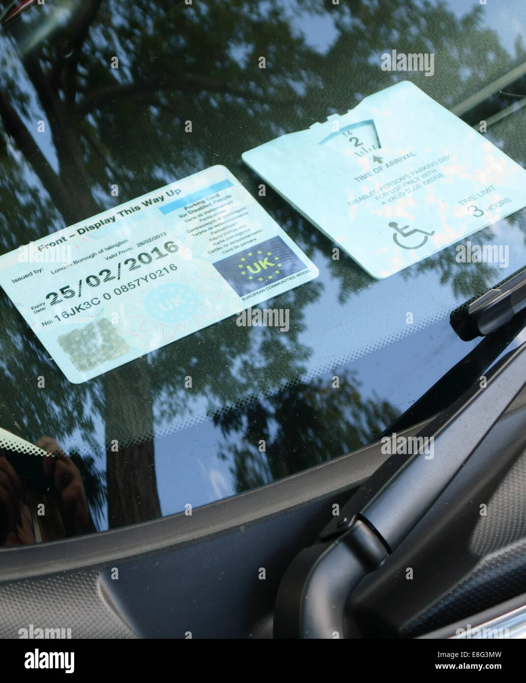 Disabled person parking permit (blue badge) displayed in car in London Stock Photo