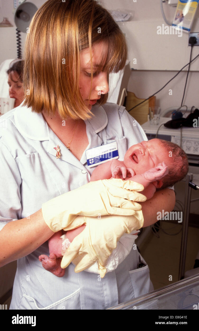 student midwife holding newborn baby in maternity hospital Stock Photo
