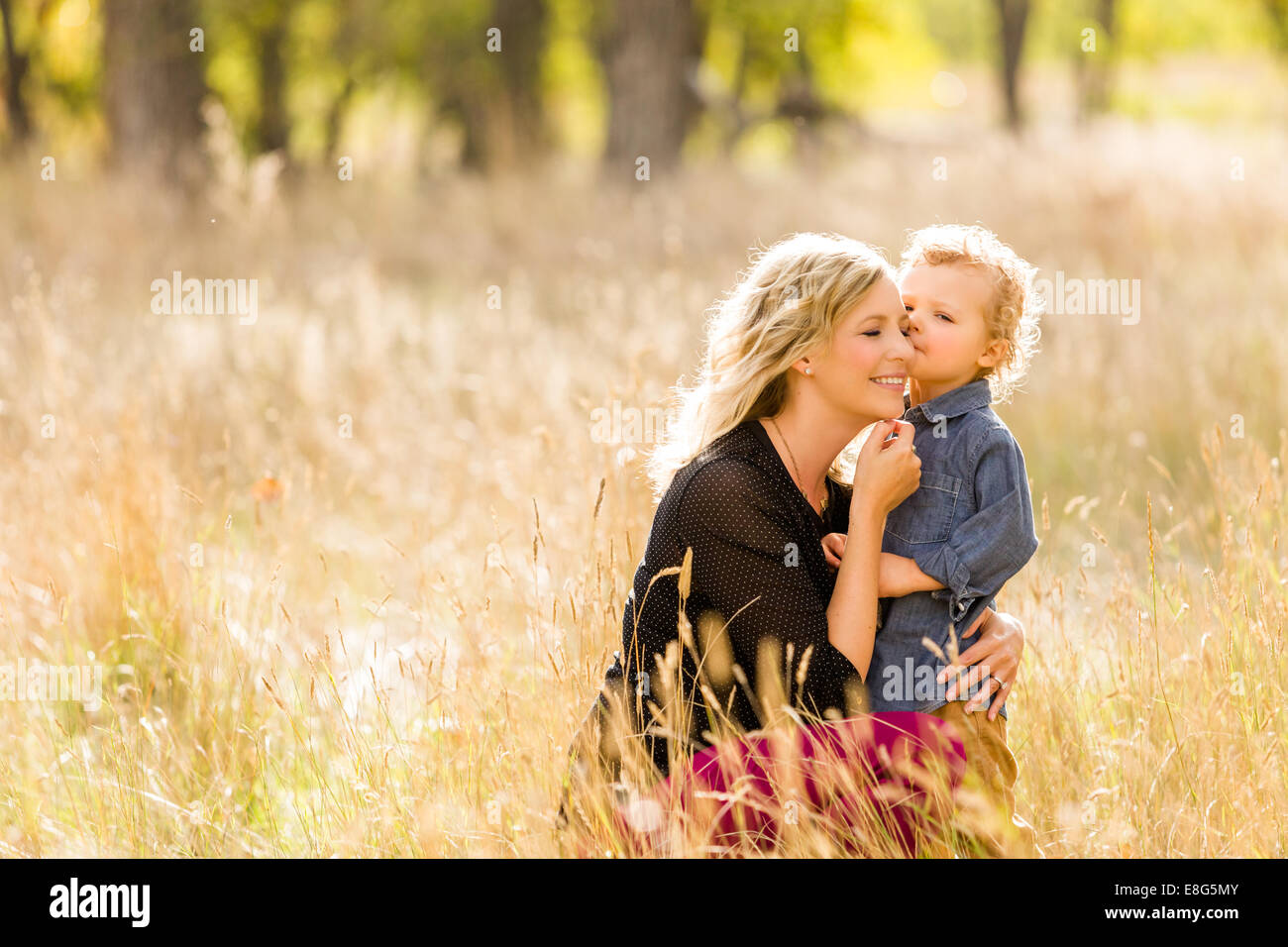 Lovely family enjoying weekend in open space park in early Autumn Stock ...