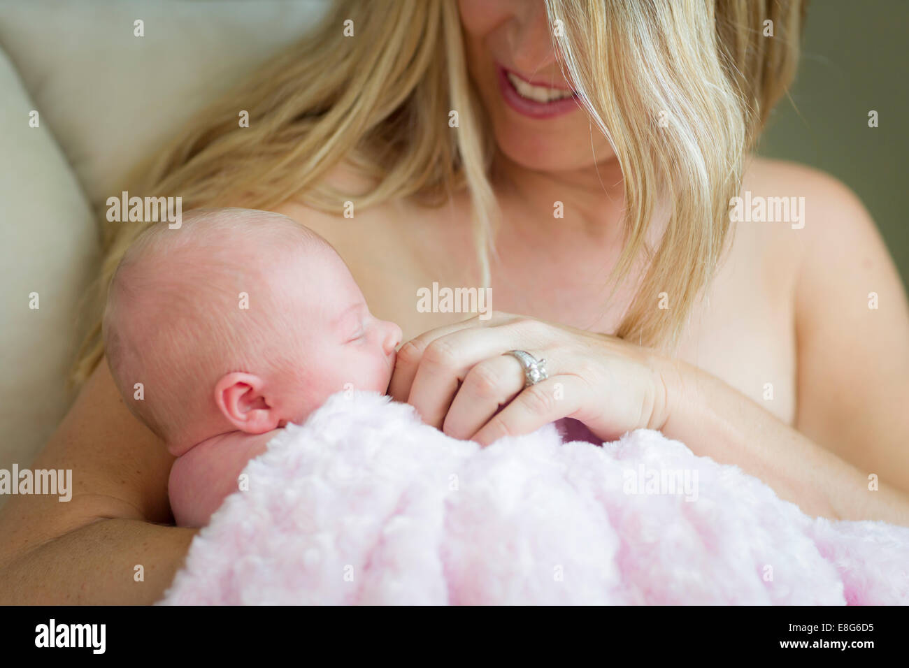 Young Caucasian Beautiful Mother Holding Her Precious Newborn Baby Girl. Stock Photo
