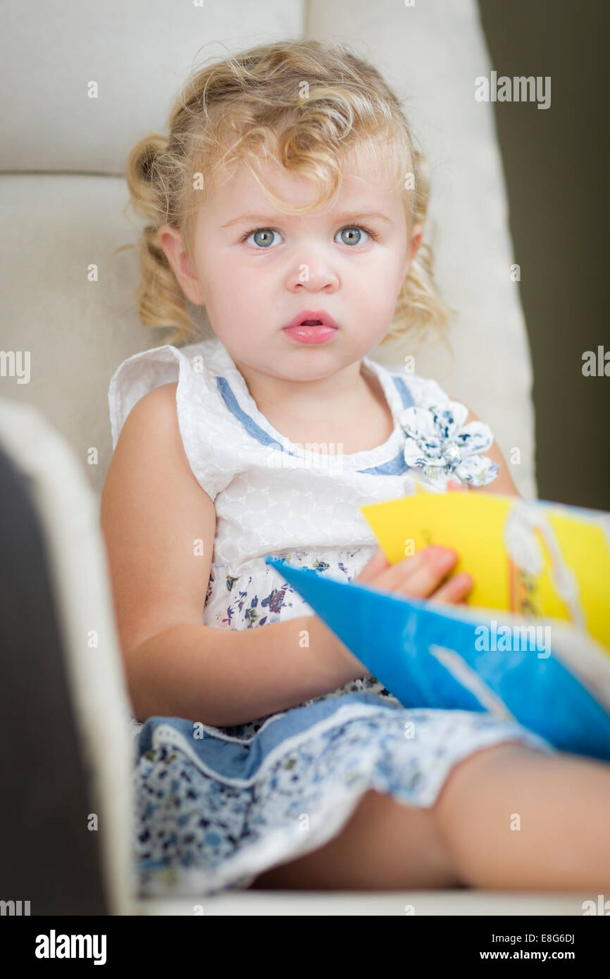 Adorable Blonde Haired Blue Eyed Little Girl Reading Her Book in the