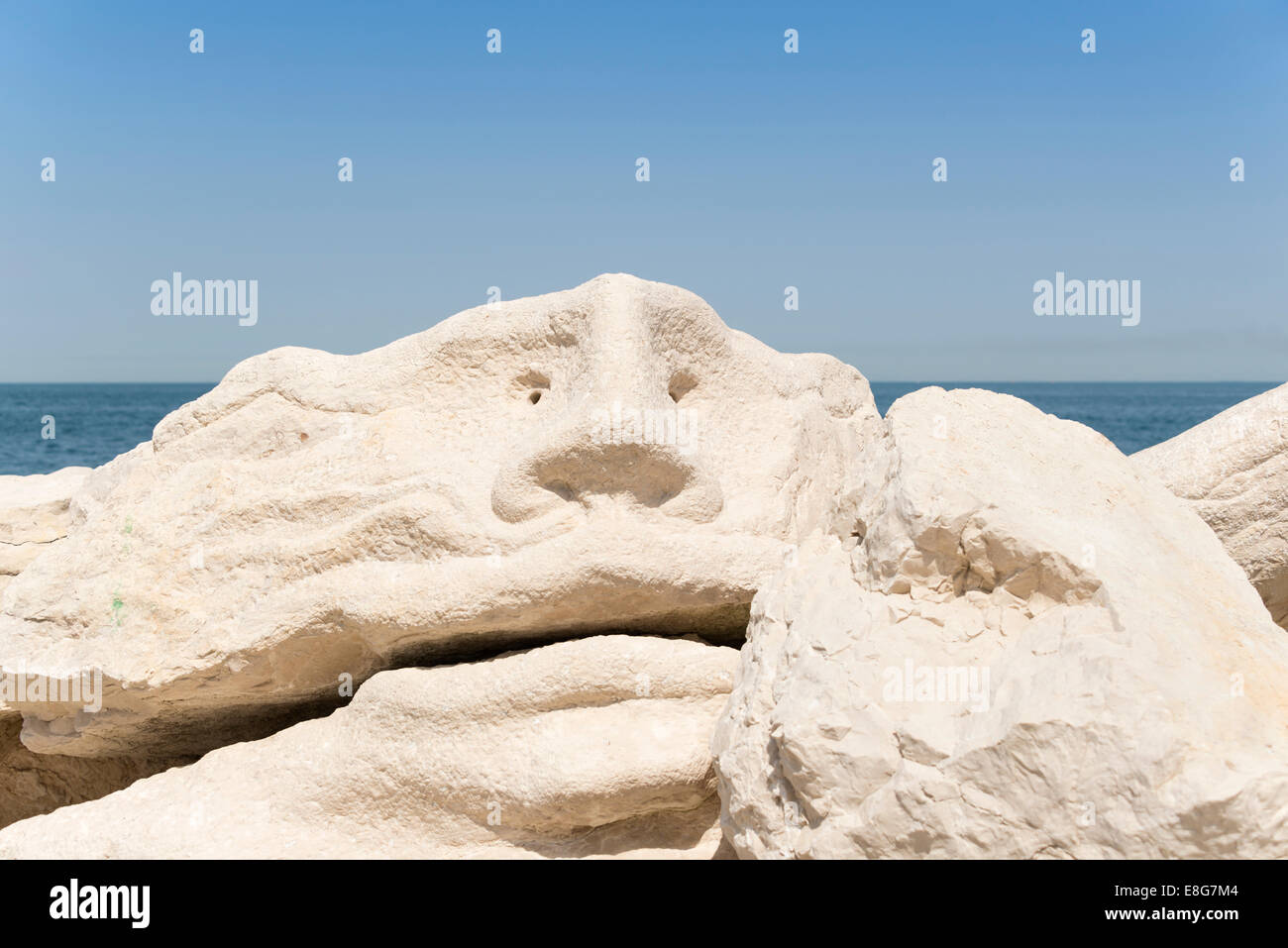 Face sculpture by the sea, Piran, Slovenia. Stock Photo