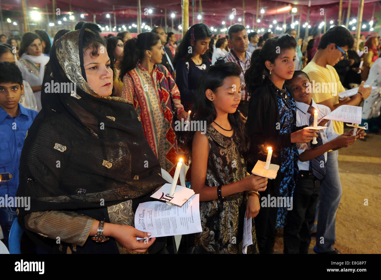 Christian women praying with candles, holy mass service at roman