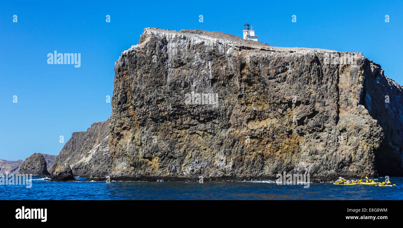 Kayaks off Anacapa Island in Channel Islands National Park, with sea lions  on rocks Stock Photo