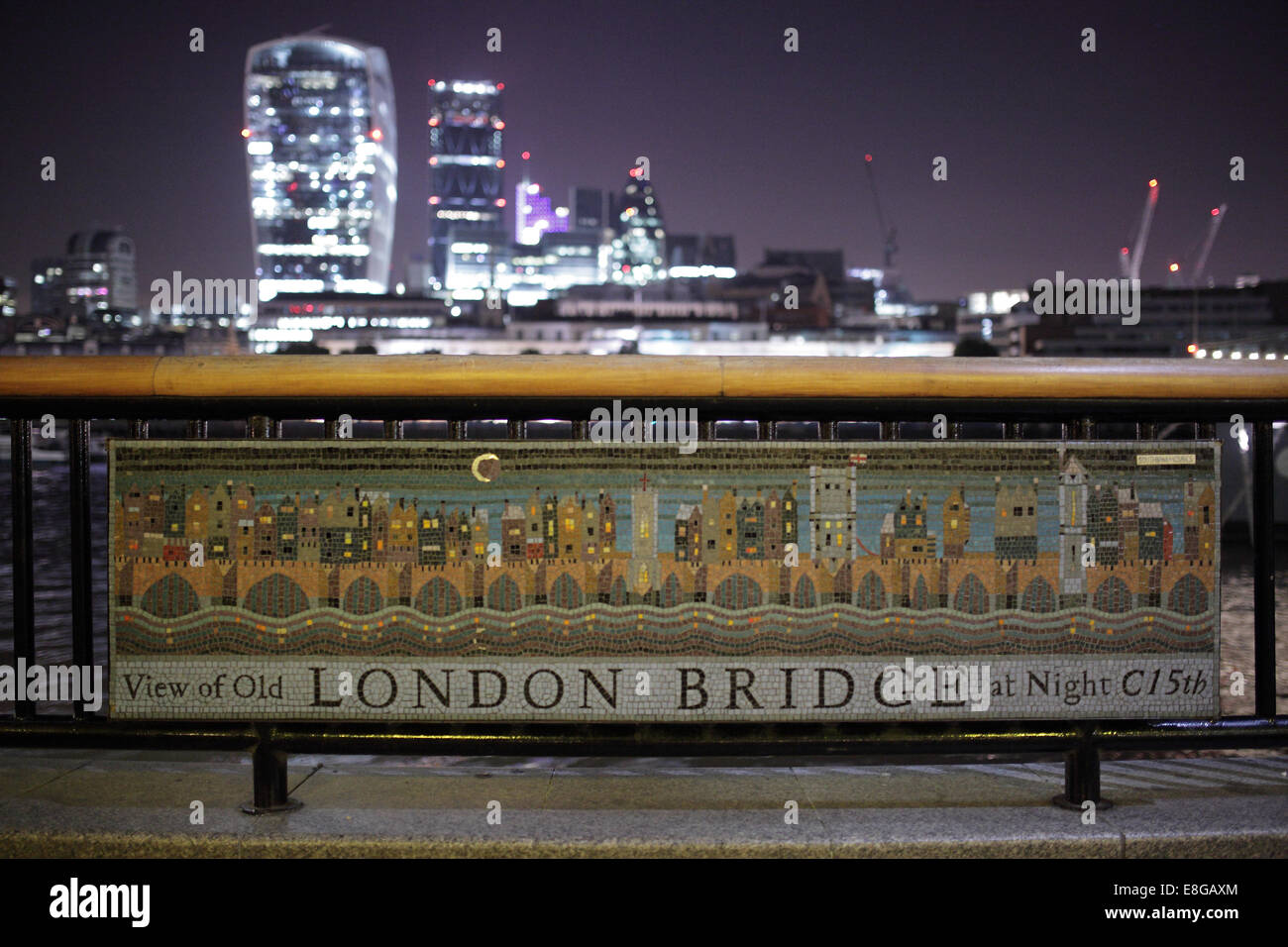 Old London Bridge mosaic sign next to the River Thames in London at night. Stock Photo