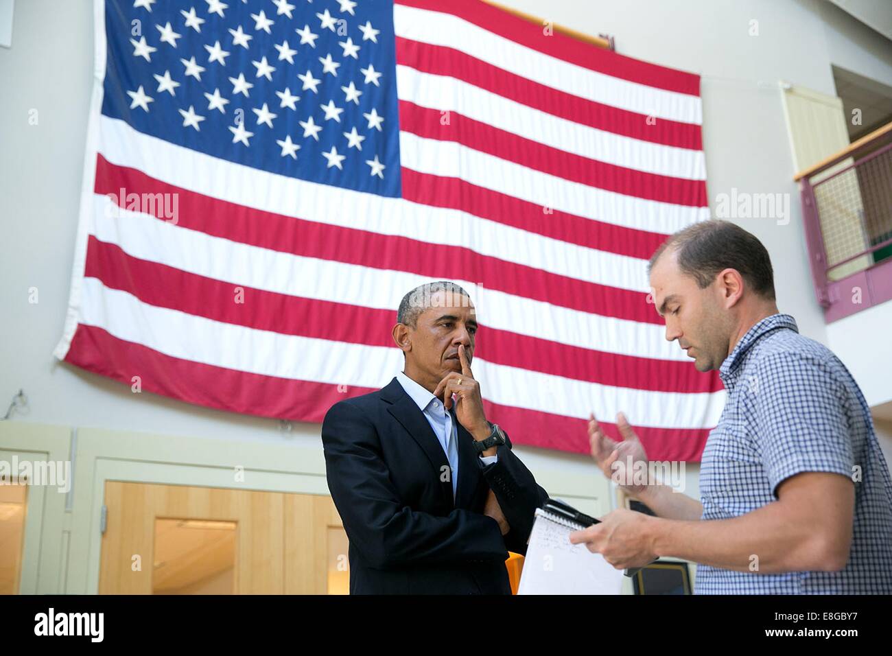 US President Barack Obama talks with Ben Rhodes, Deputy National Security Advisor for Strategic Communications, after delivering a statement on the murder of journalist Jim Foley by the terrorist group ISIL at the Edgartown School August 20, 2014 in Edgartown, Martha's Vineyard, Massachusetts. Stock Photo