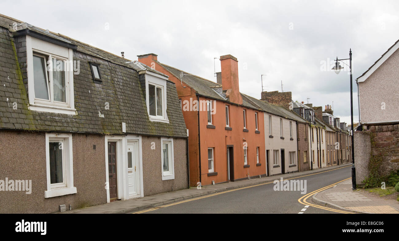 Row of bland terrace houses crammed together along narrow street in coastal town of Arbroath, Scotland Stock Photo