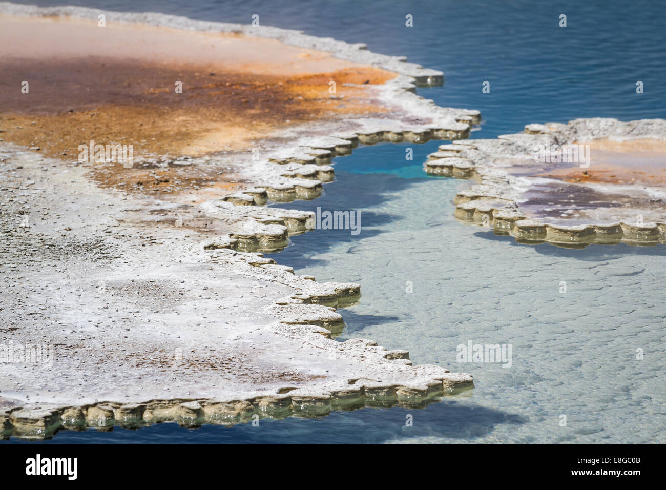 close up of the minerals forming a shell over the vibrant blue waters ...