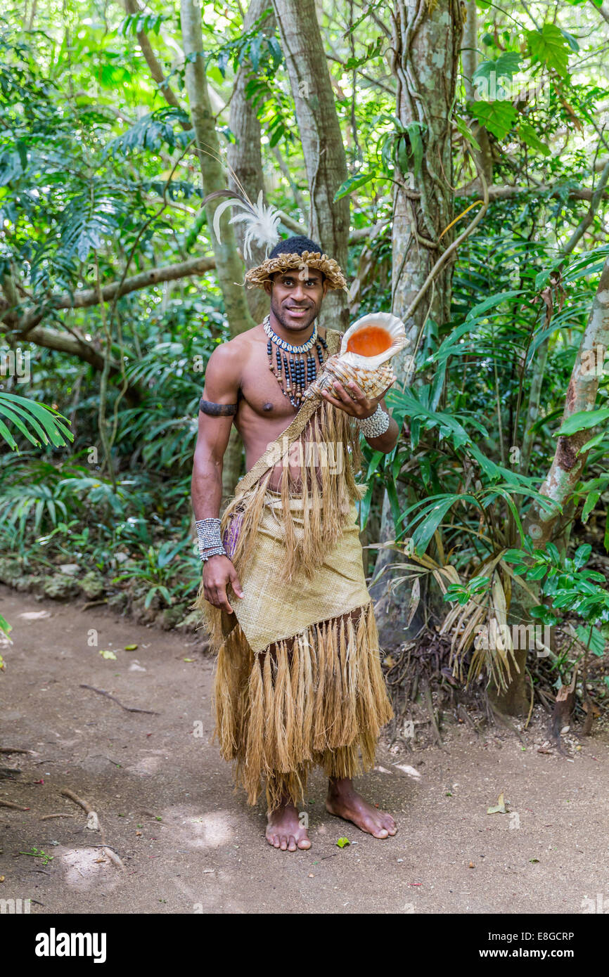 Melanesian guide demonstrating conch shell at Vila, Vanuatu. Stock Photo