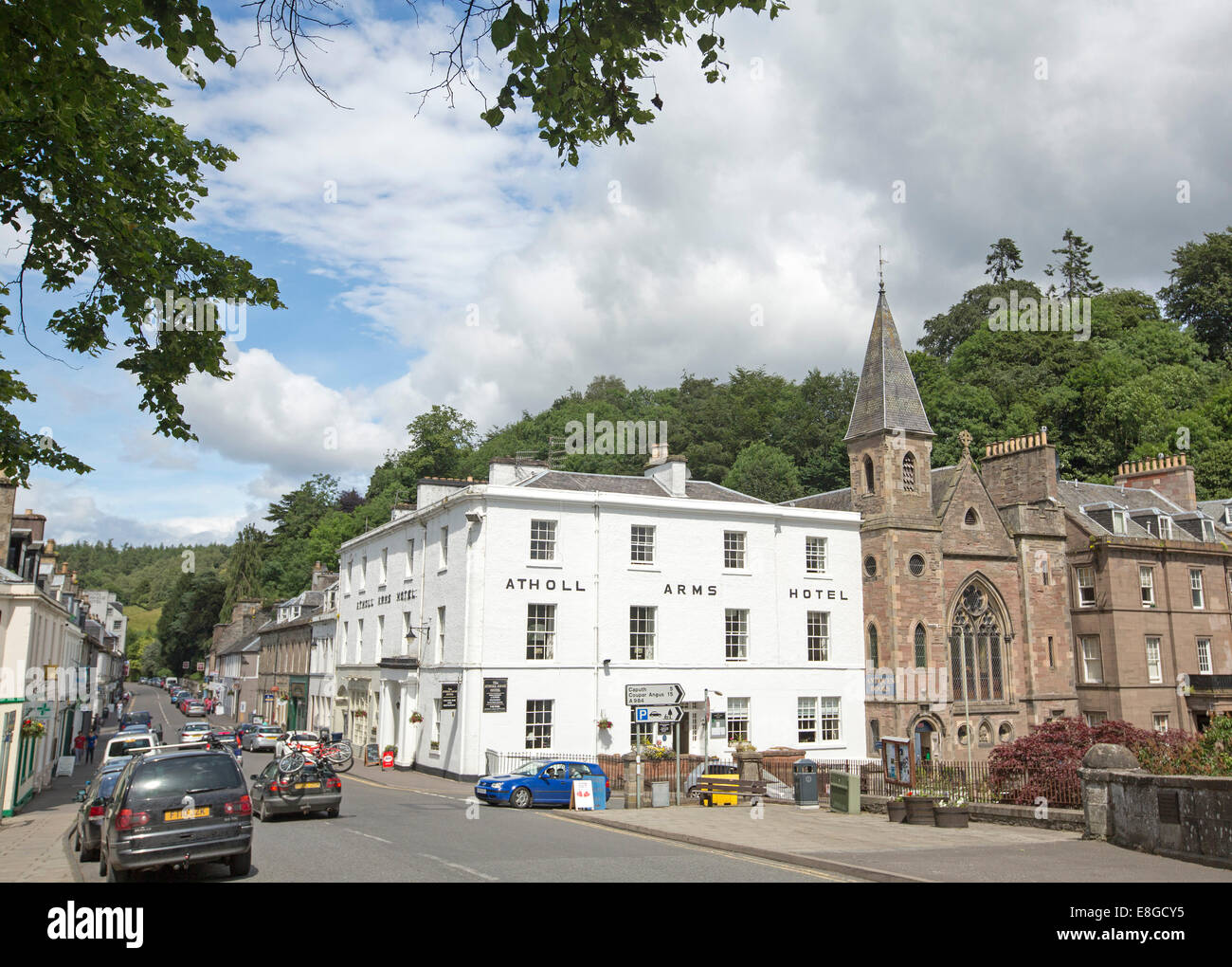 Main street of Scottish town of Dunkeld with historic 19th century Atholl Arms Hotel and old church in foreground Stock Photo