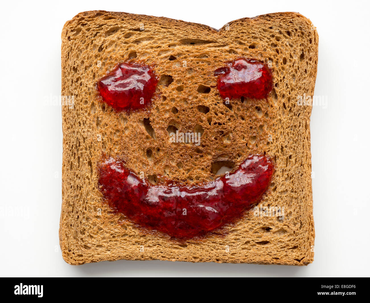 fried toast with red jam in shape of smile Stock Photo