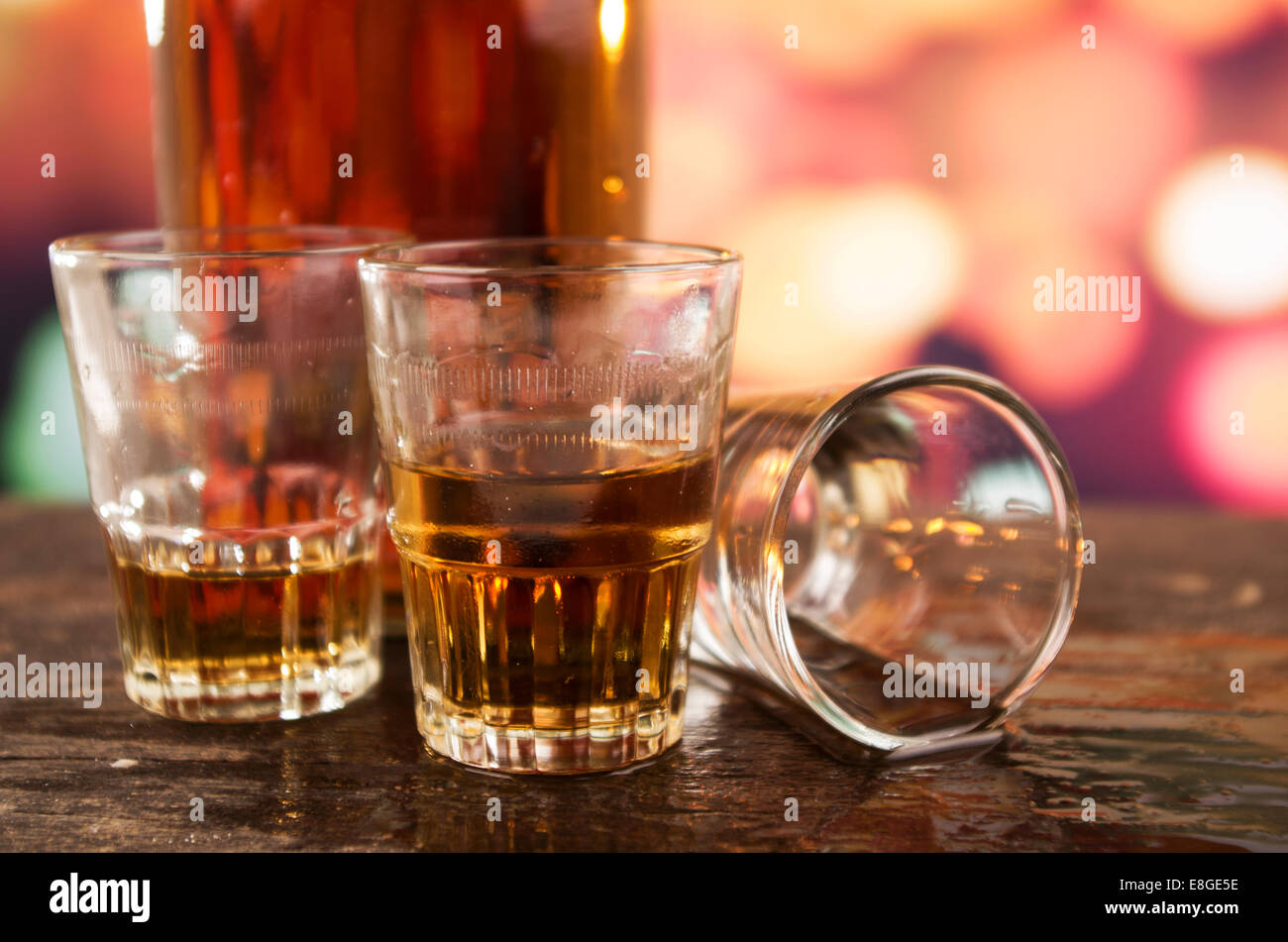 glass of rum whiskey over defocused lights background Stock Photo Alamy