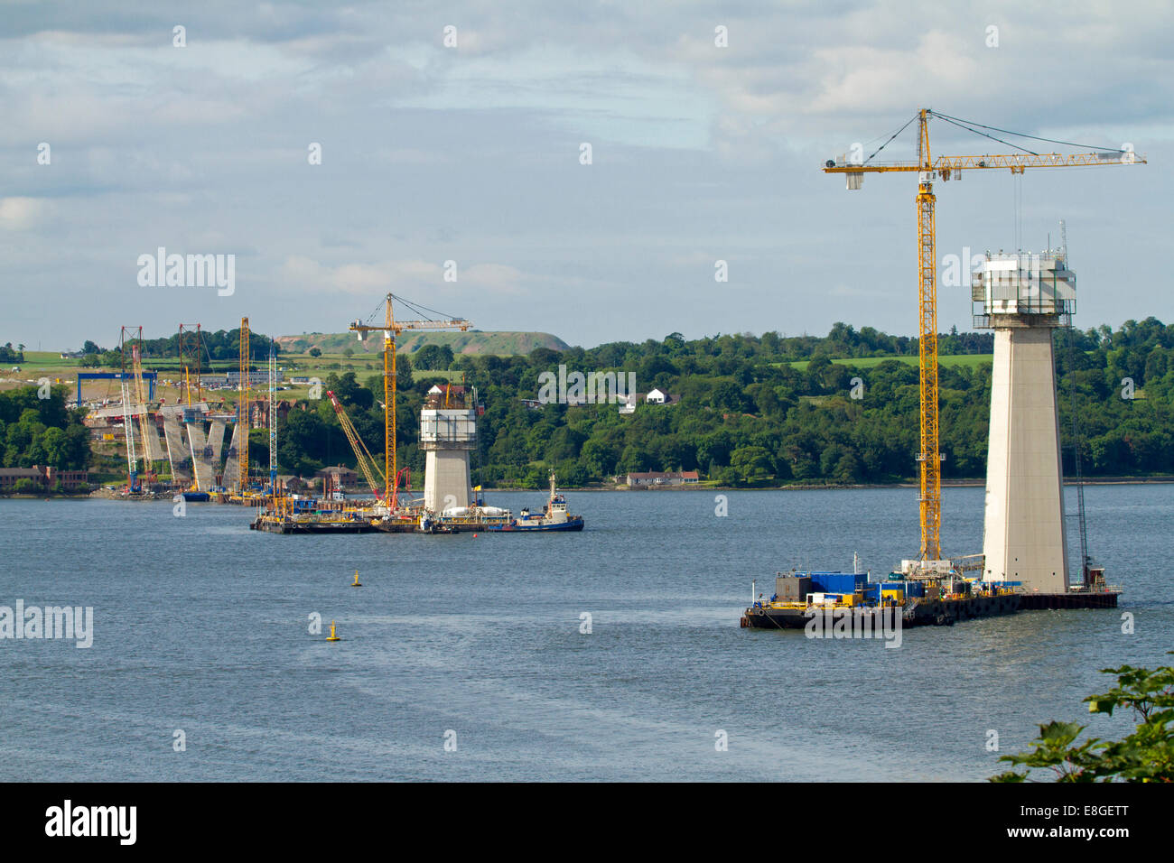 New suspension bridge, Queensferry Crossing, under construction over Firth of Forth with cranes reaching into blue sky near Edinburgh Scotland Stock Photo