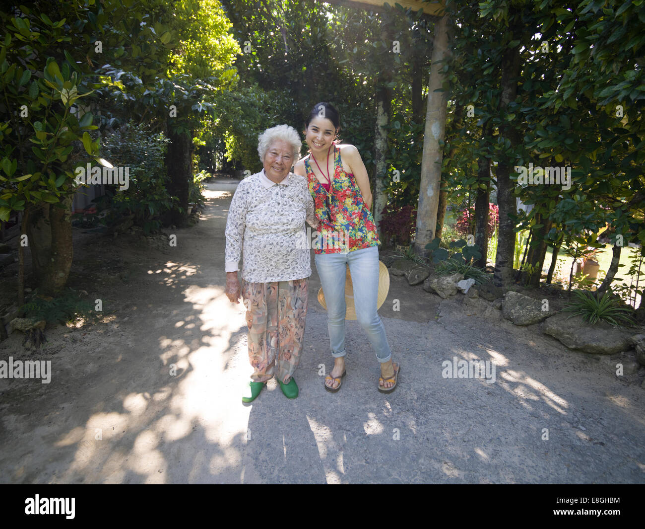 Meeting a local elderly Okinawan woman at Bise Fukugi Tree Road, Motobu, Okinawan women have world's longest life expectancy. Stock Photo