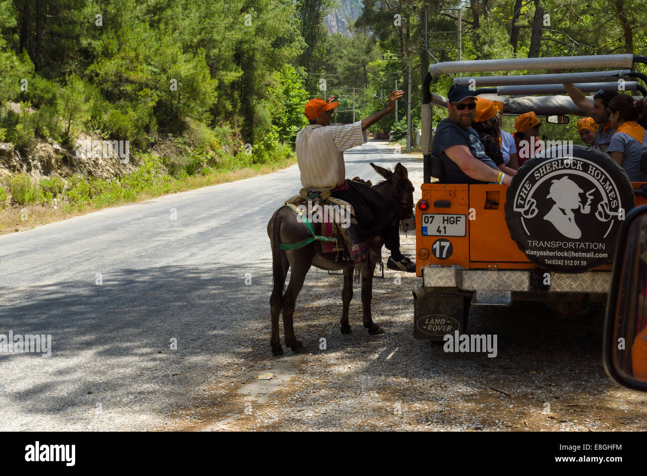 Turkey Riding Donkey ALANYA, TURKEY - JUNE 27, 2014: Village resident entertains tourists ...