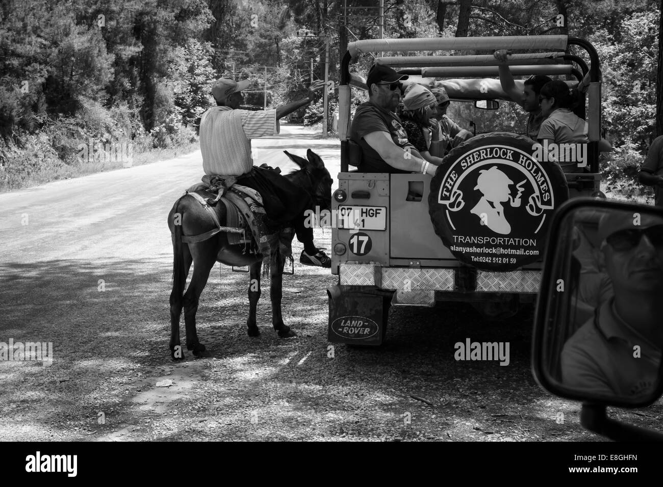 Turkey Riding Donkey ALANYA, TURKEY - JUNE 27, 2014: Village resident entertains tourists ...