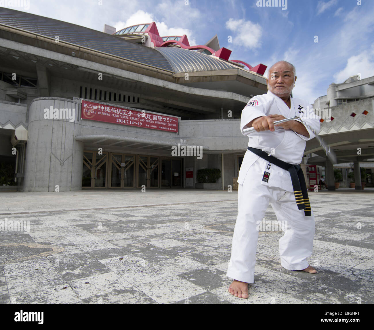 Masahiro Nakamoto - Hanshi 10th dan, Okinawa Dentou Kobudo with nunchaku outside the Budokan, Naha City, Okinawa Stock Photo