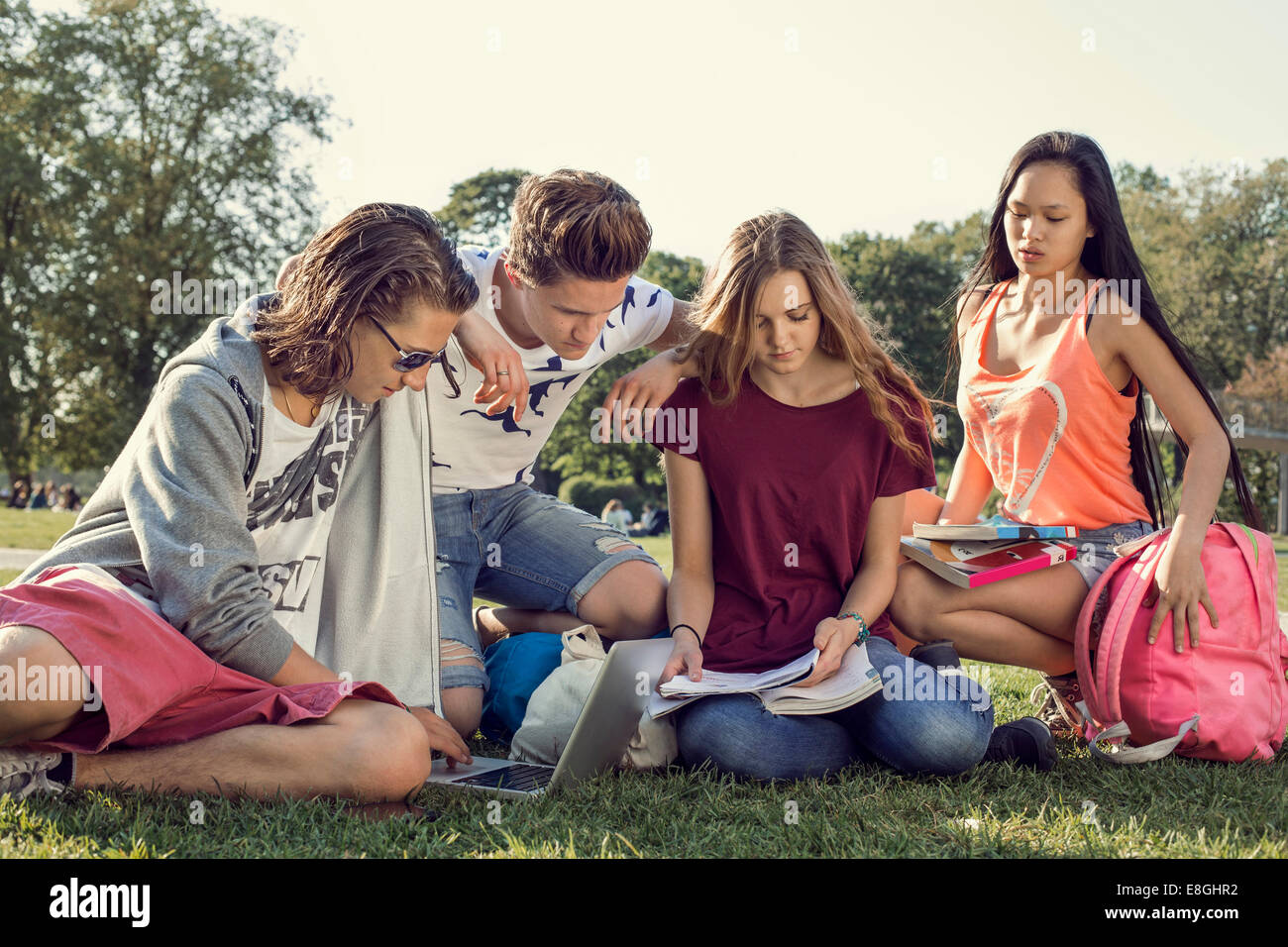Group of friends studying on high school schoolyard Stock Photo