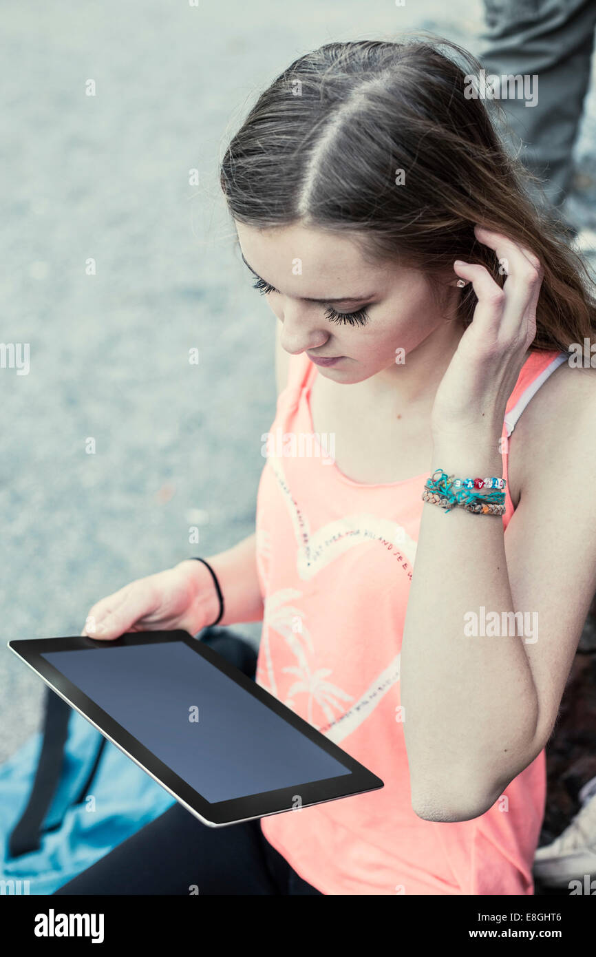 High angle view of female high school student using digital tablet outdoors Stock Photo