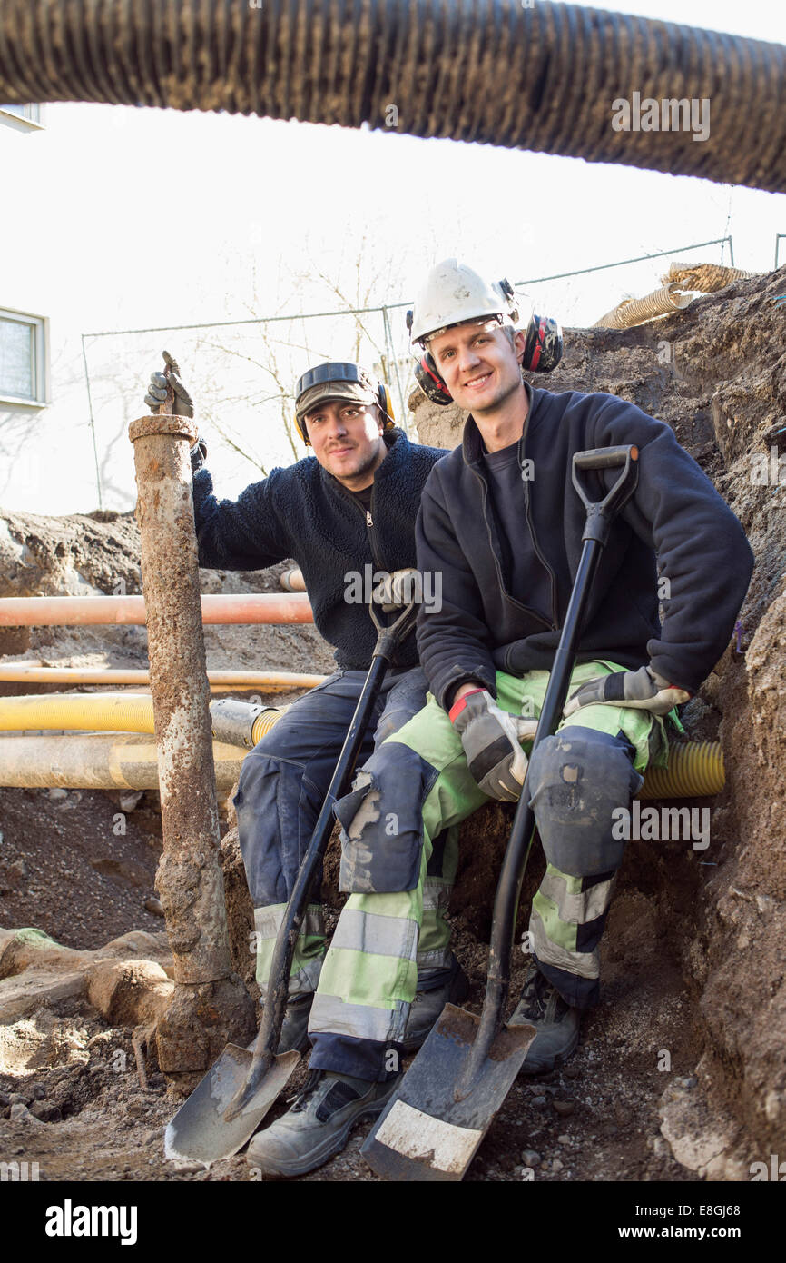 Portrait of smiling workers at construction site Stock Photo - Alamy
