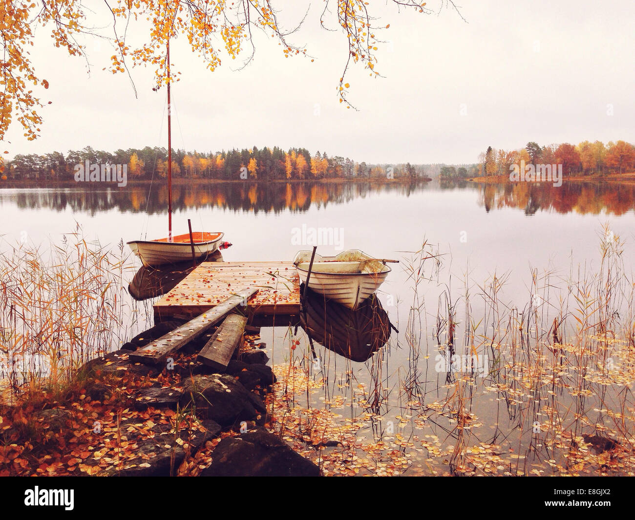 Sweden, Boats at tranquil lake Stock Photo