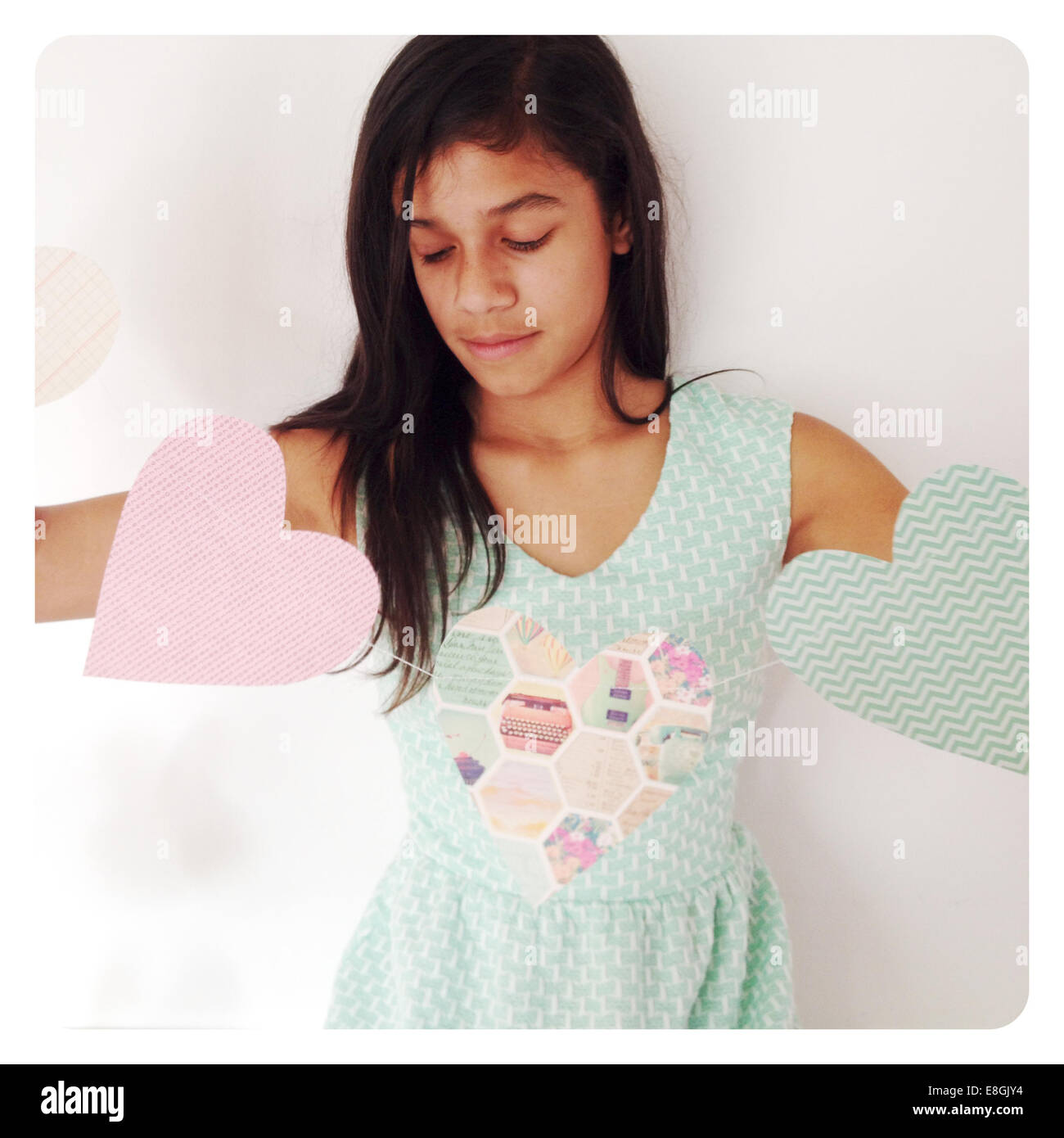 Girl holding a Valentine's Day decorative banner with heart shapes Stock Photo