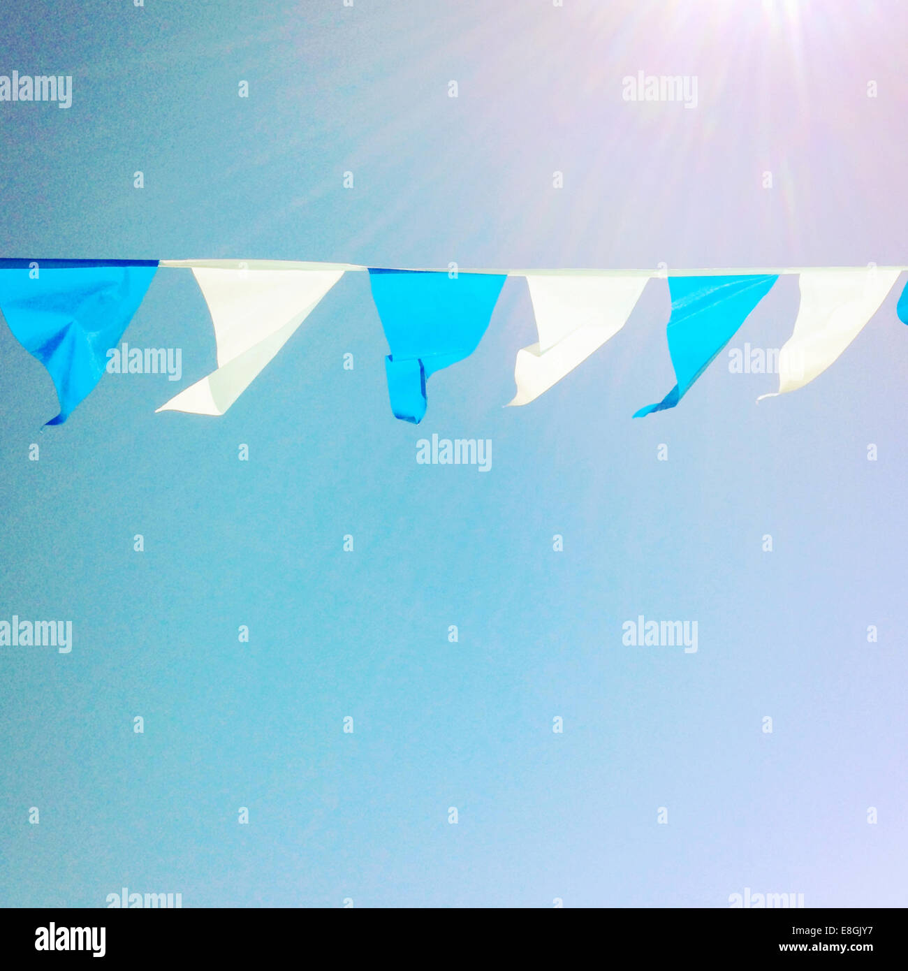 Bunting hanging against blue sky Stock Photo