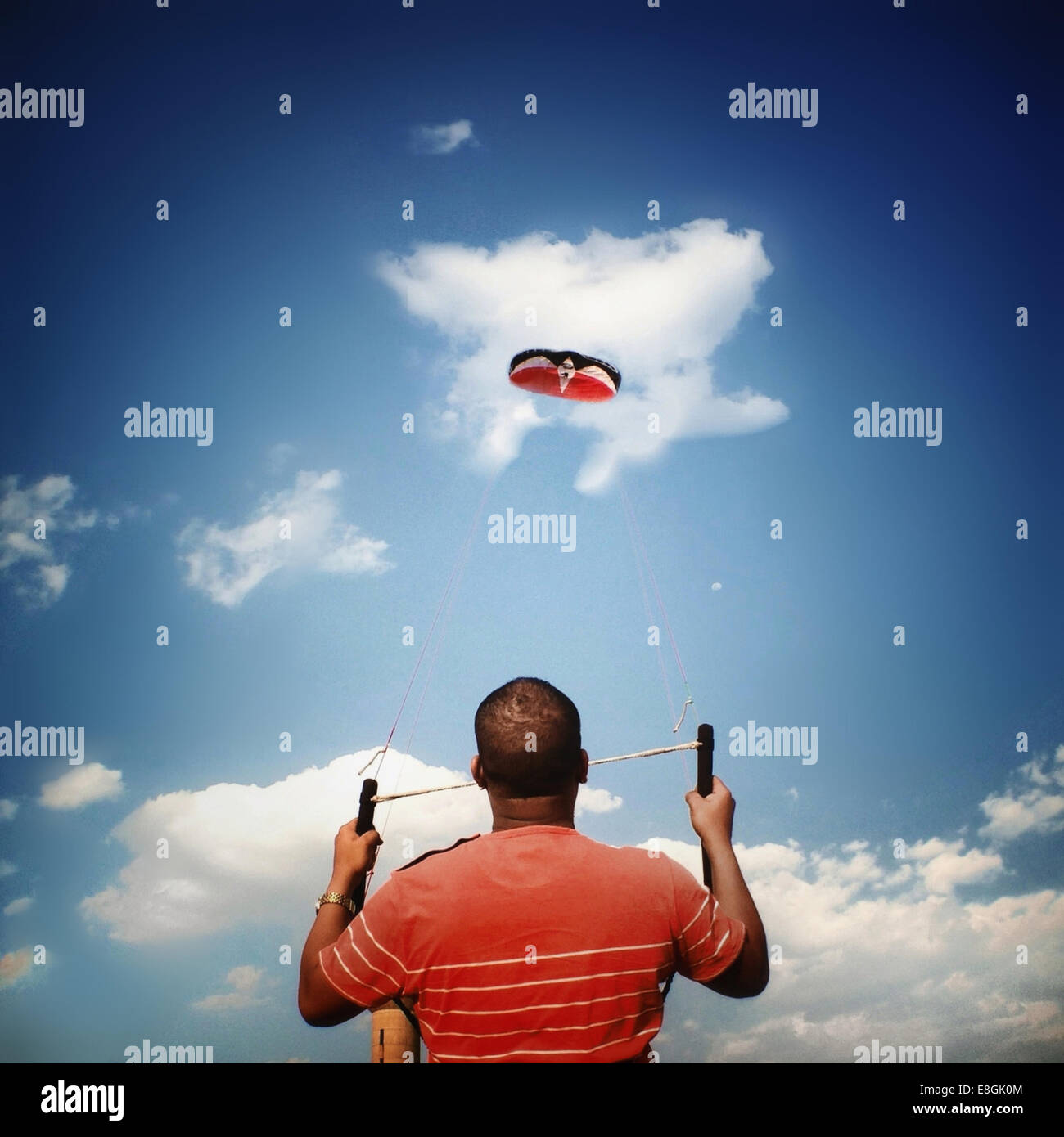 Rear view of a man flying a kite Stock Photo