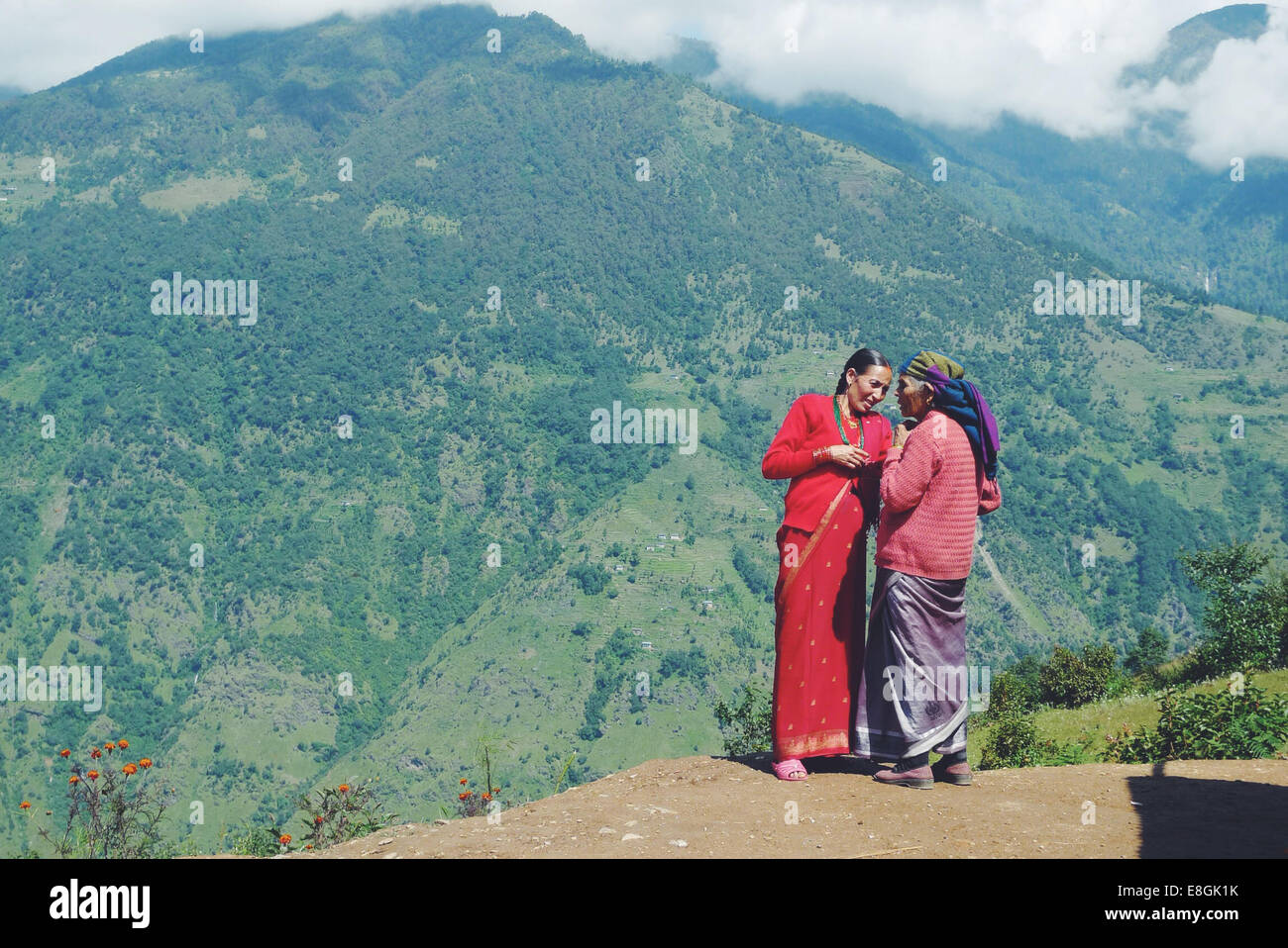Nepal, Women standing and talking in mountains Stock Photo