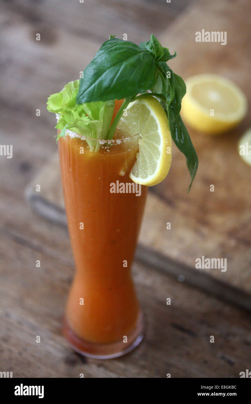 Bloody Mary Cocktail with celery, lemon, salt and basil Stock Photo Alamy