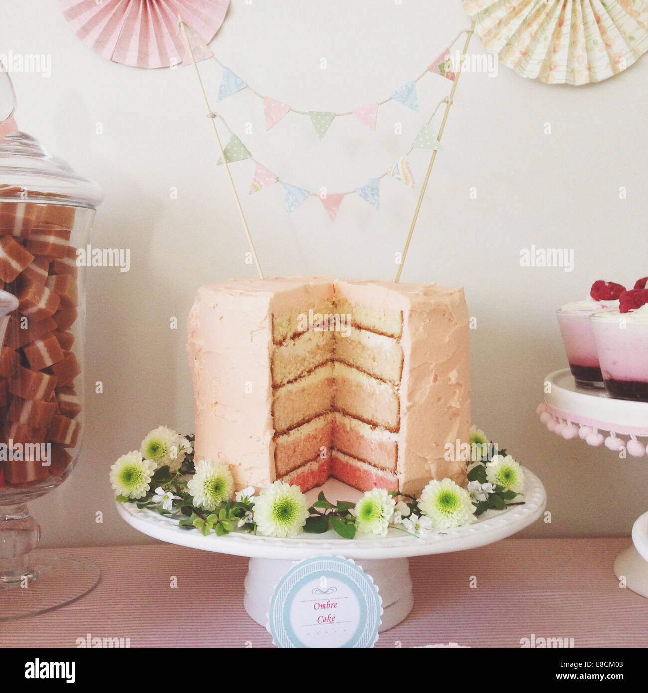 Pink Ombre cake with large slice removed Stock Photo