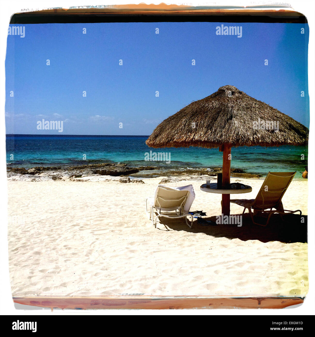 Sun loungers and sun umbrella on beach, Cozumel Island, Yucatan Peninsula, Mexico Stock Photo