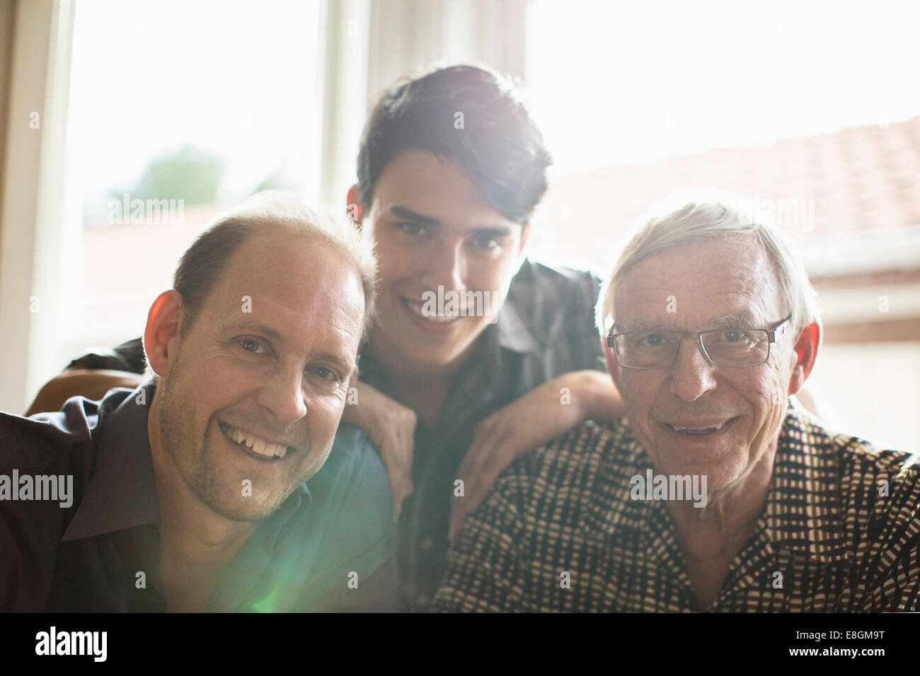 Portrait of three generation family smiling together at home Stock Photo