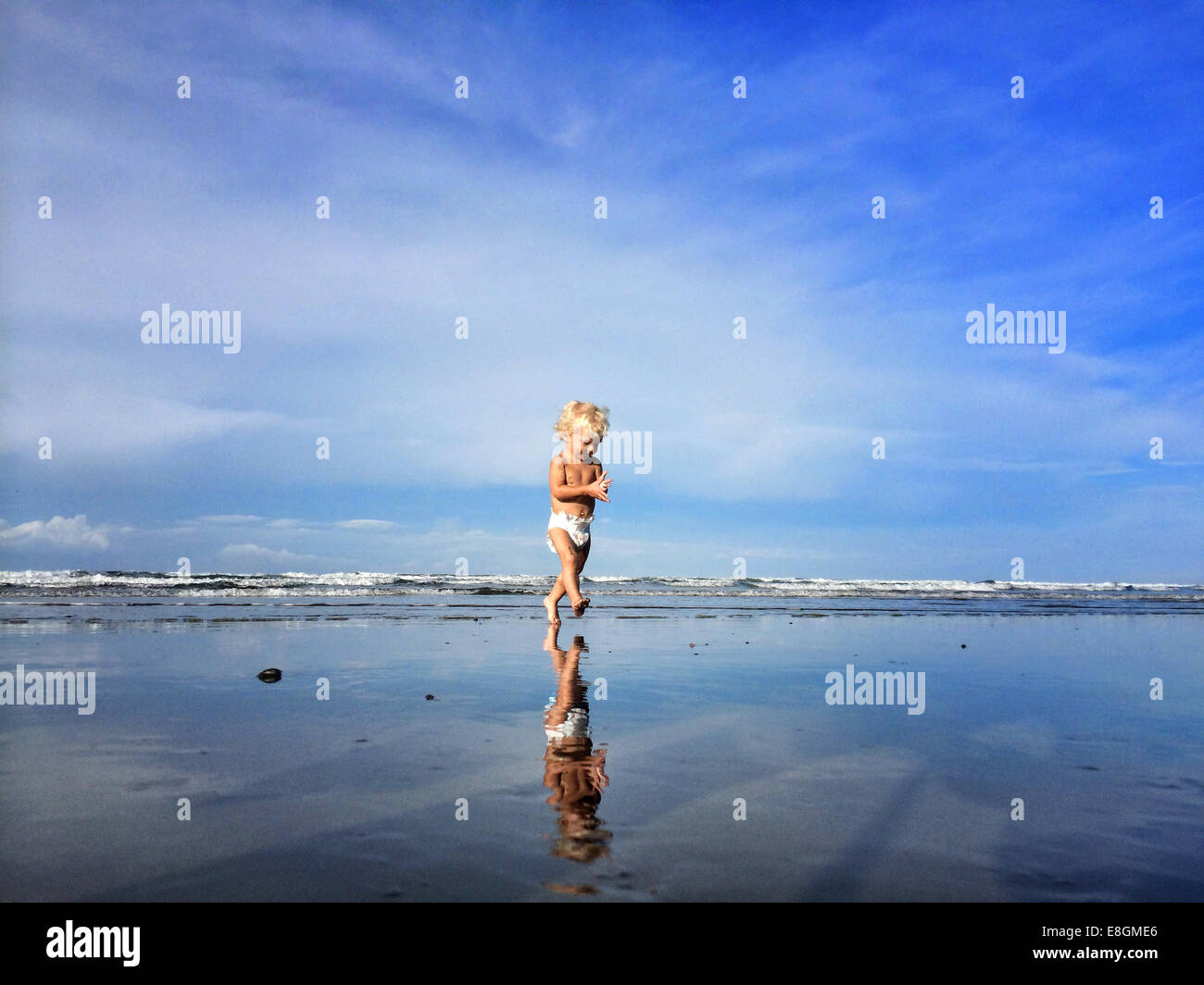 Toddler walking on beach, Orange County, California, USA Stock Photo