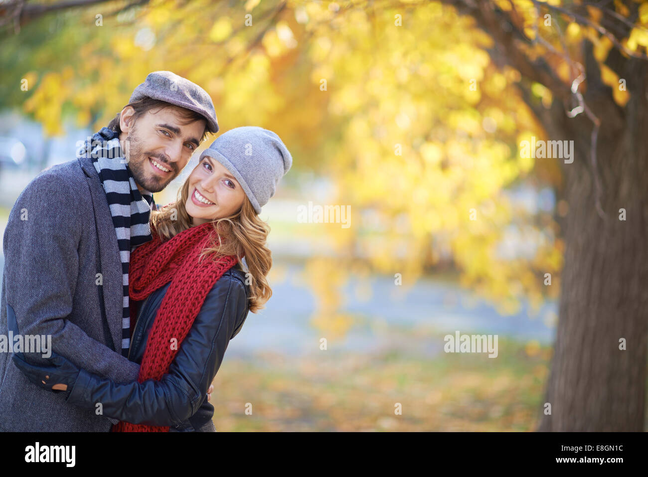 Portrait of a young couple in autumn park Stock Photo - Alamy