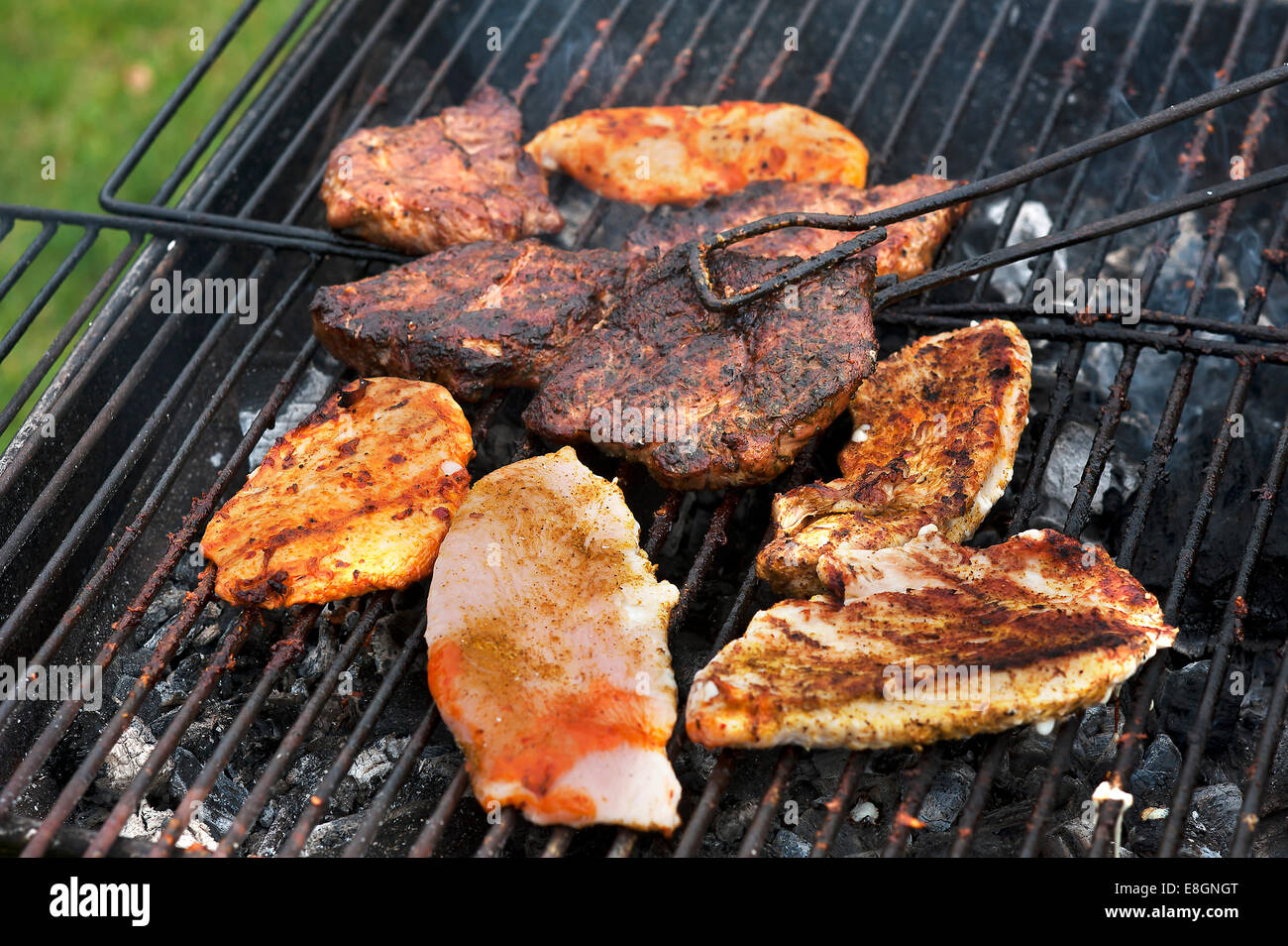 Heavily roasted meat on a charcoal grill Stock Photo - Alamy