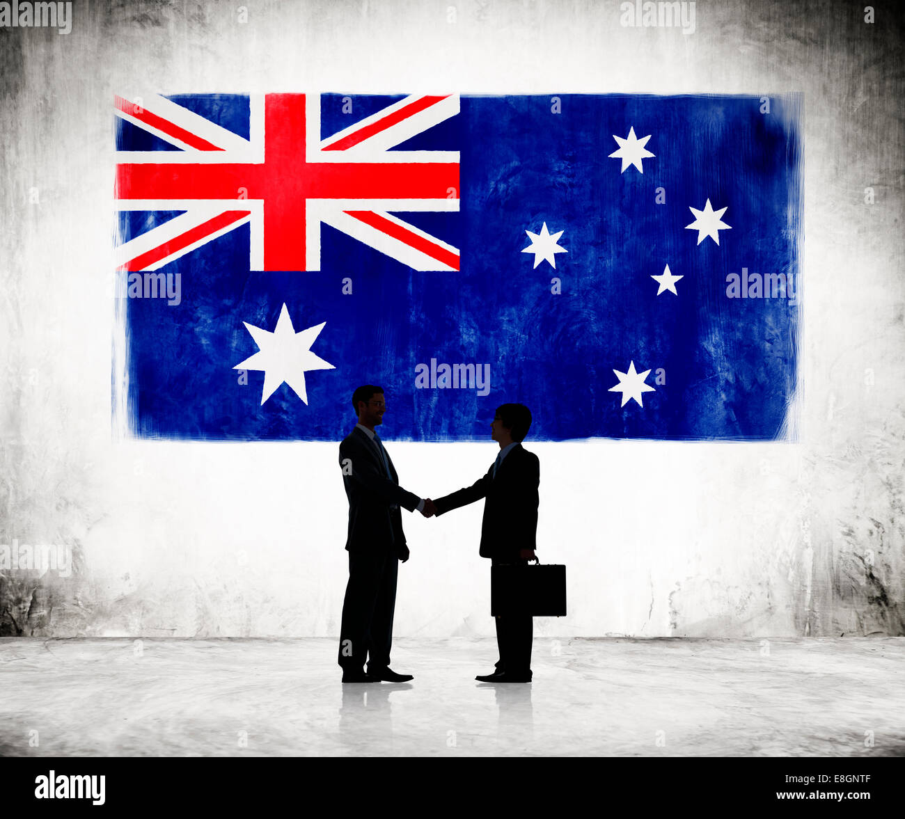 Two Businessmen Shaking Hands With Austrailian Flag As A Background Stock Photo