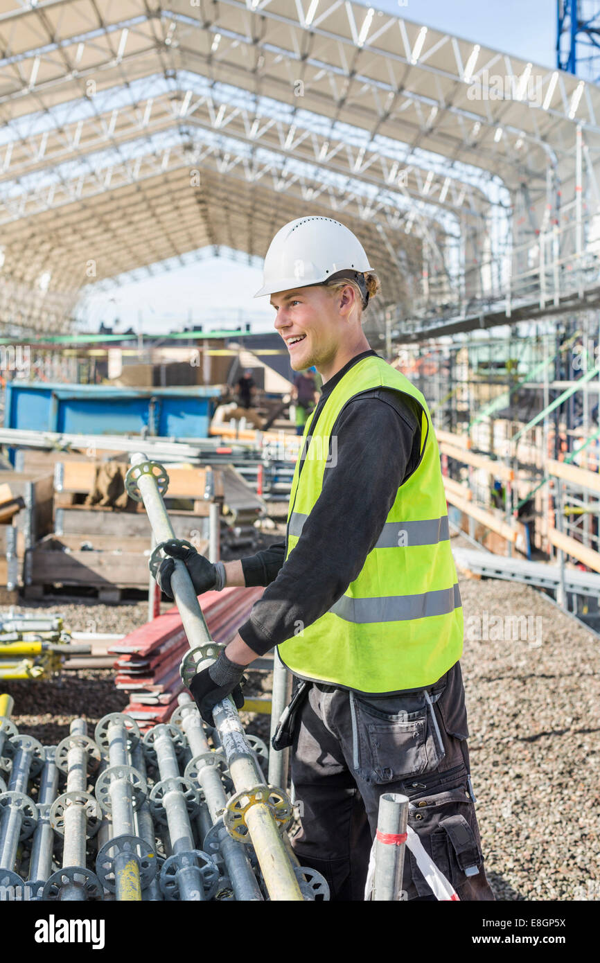 Happy construction worker working at site Stock Photo - Alamy