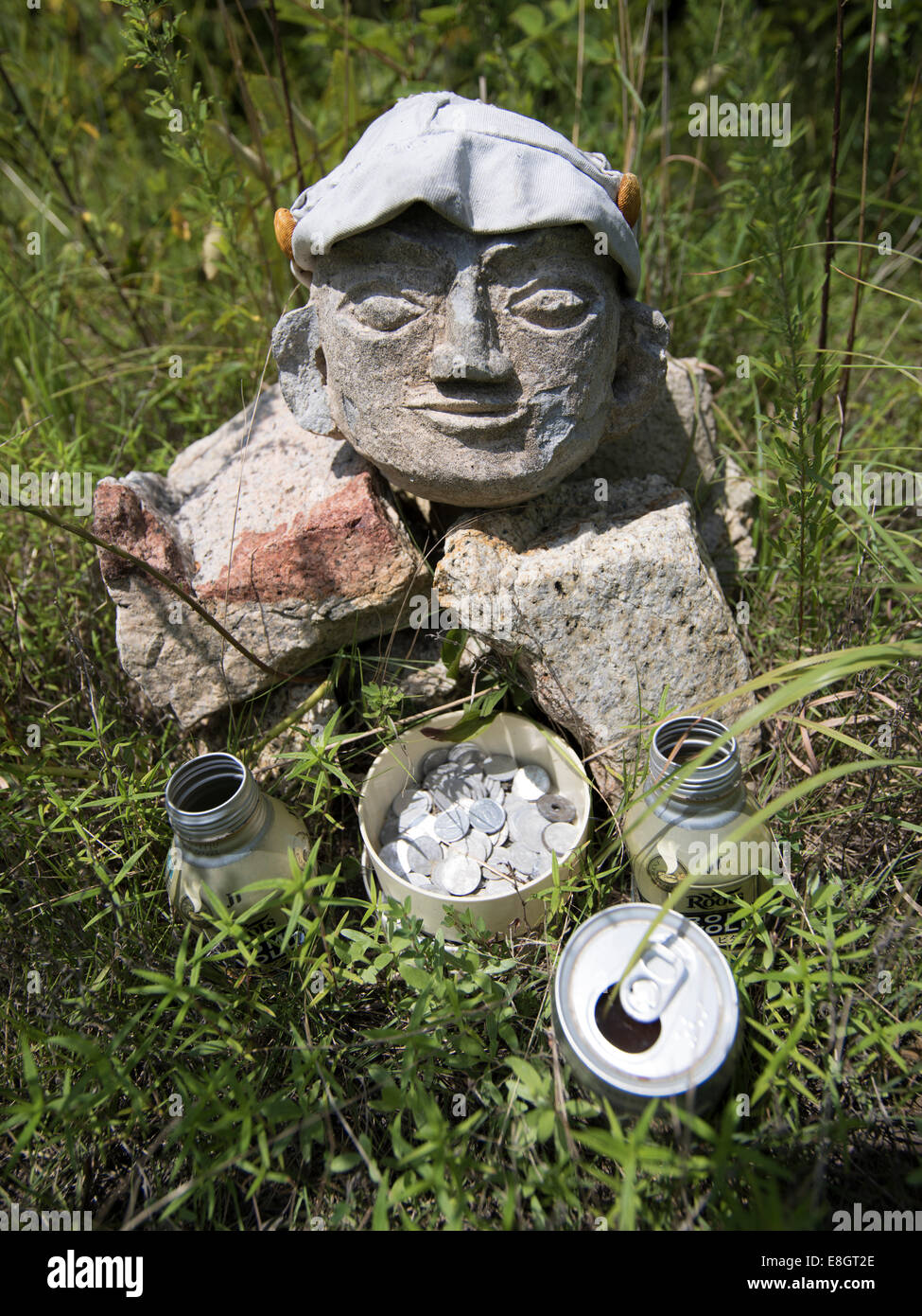 Ojizo Statue with offerings of drinks and money. Naoshima, Japan Stock Photo